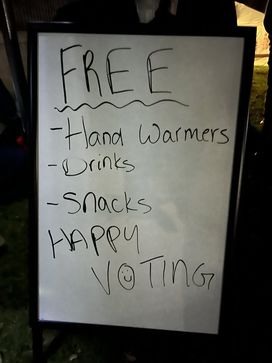 The wait to register at the end of the line is three ish hours. A nonprofit is giving out chips and hand warmers and hot cocoa and bars to keep people motivated to wait in Missoula. “Pizza, anybody?” said a person walking the line. Some people brought books to read. #mtpol