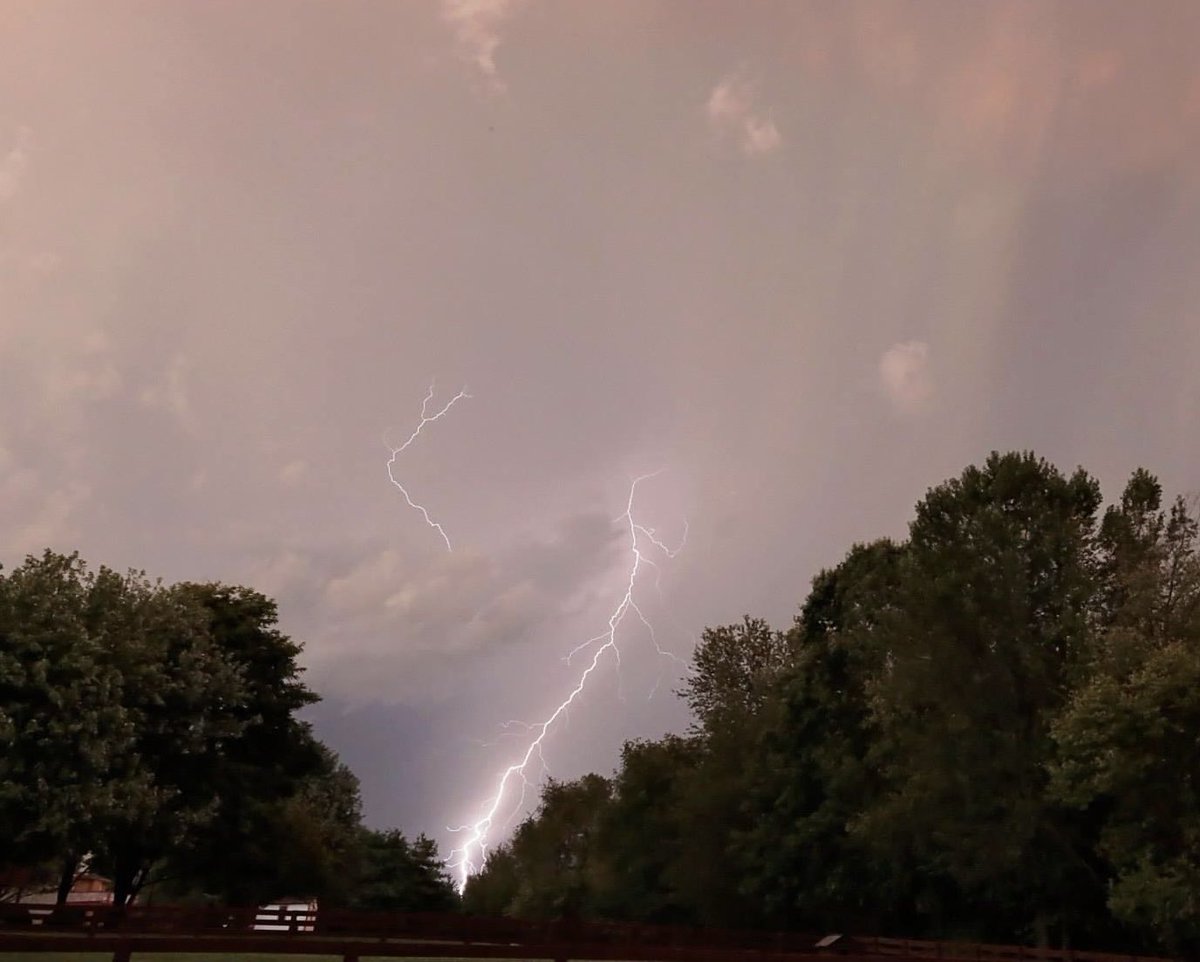 bairdly's tweet photo. @Nick_Pettigrew Backyard shot years ago. Like the way the lightning split the valley of the tree line. https://t.co/dS5QCawCJz