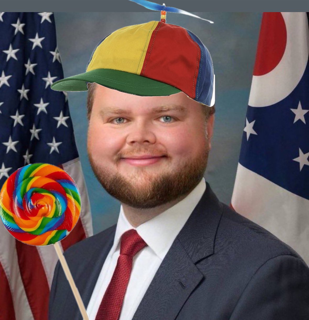 jd vance with a propeller hat and a lollipop