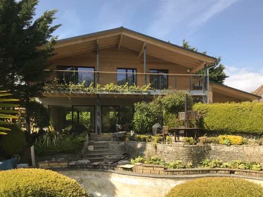 This chalet style home has a luxurious and cosy ambience. The roof overhang frames the balcony, providing shelter in all weathers.