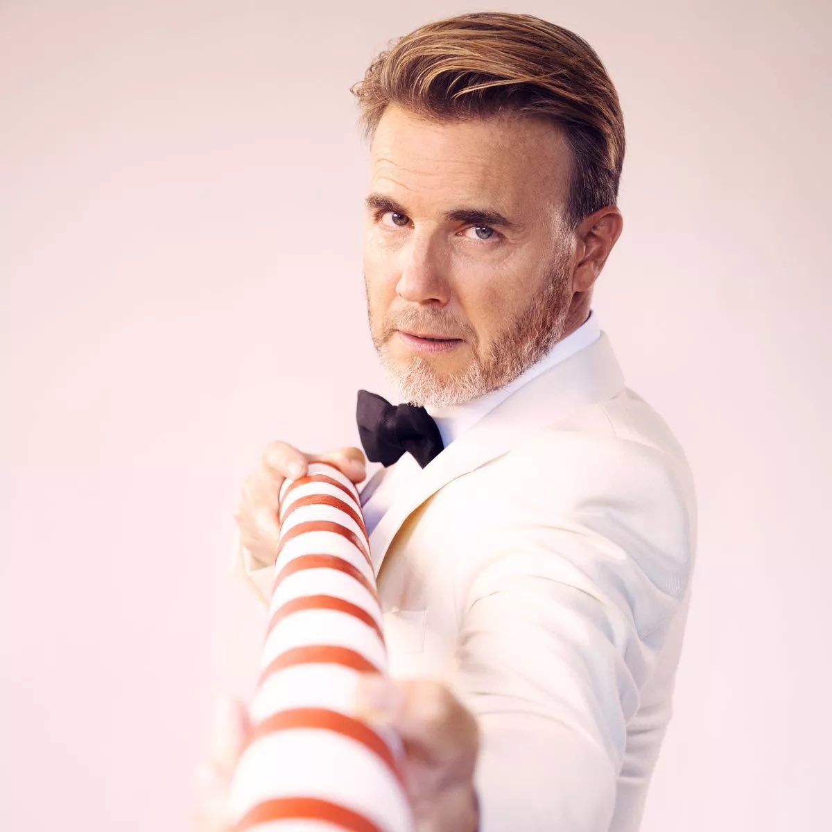 Gary Barlow feeding his son a candy cane at christmas