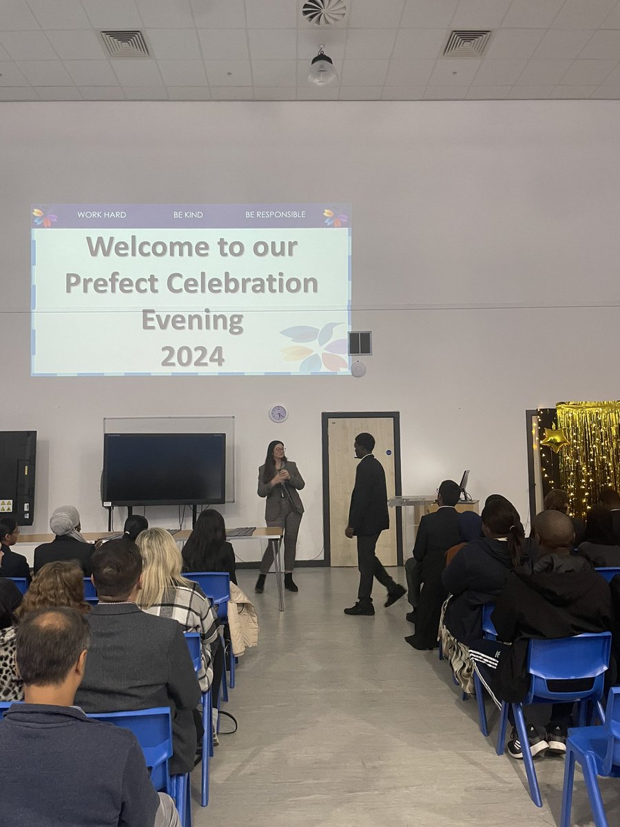 StuartMortonRA's tweet photo. Fantastic presentation evening for our new prefects. Parents look on proudly at their children that embody the Orchard Oath and choose to be role models for their peers.  Amazing young people that we work with. @OrchardMead @TMETrust https://t.co/hVxo0Y6fGg
