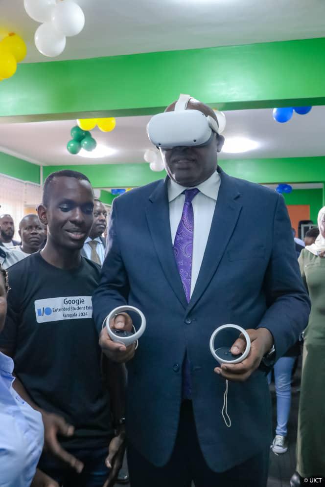 UICTug's tweet photo. Dr. @CHRISBARYOMUNS1 - Minister of @MoICT_Ug experiments the use of #VirtualReality during the grand opening of the AVR Cluster Center @UICTug. 
#AVRLaunch24
#DigitalTransformation 
#AugmentedReality https://t.co/pWFgwbYgoW