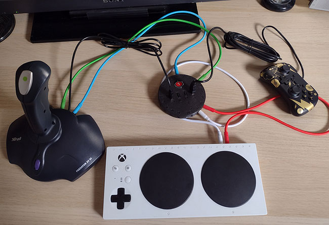 HID Remapper v6 example:

Nintendo Switch focussed. 1x large joystick. 1x recycled XAC. Both with 2x patch leads to go to any button or Walk forwards. 1x "help" gamepad.