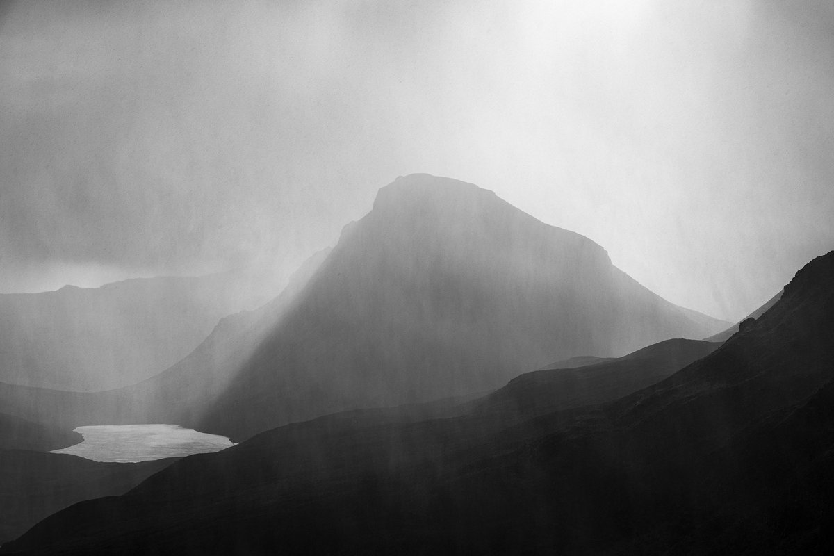 Awesome conditions last week whilst at the Quiraing guiding a group of photographers from America and Canada. 

A hail shower passes through, whilst a shaft of light falls down the left side of Cleat, making it look like water pouring down into Loch Cleat below.