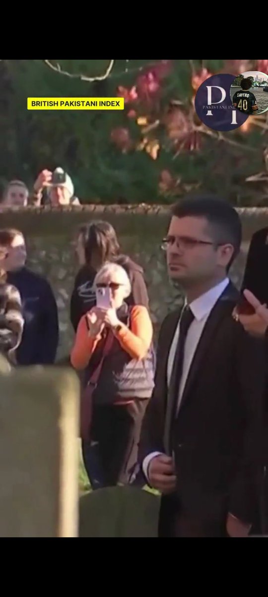 big_dryn's tweet photo. what the fuck are you filming, orange piece of shit ??

and another one HANGING on the fence

i could honestly understand coming there with flowers and standing quietly just 'cos you want to show love too. you weren't invited, but at least that would be moral.
BUT WTF IS THIS ??? https://t.co/b2gEzhJrLA