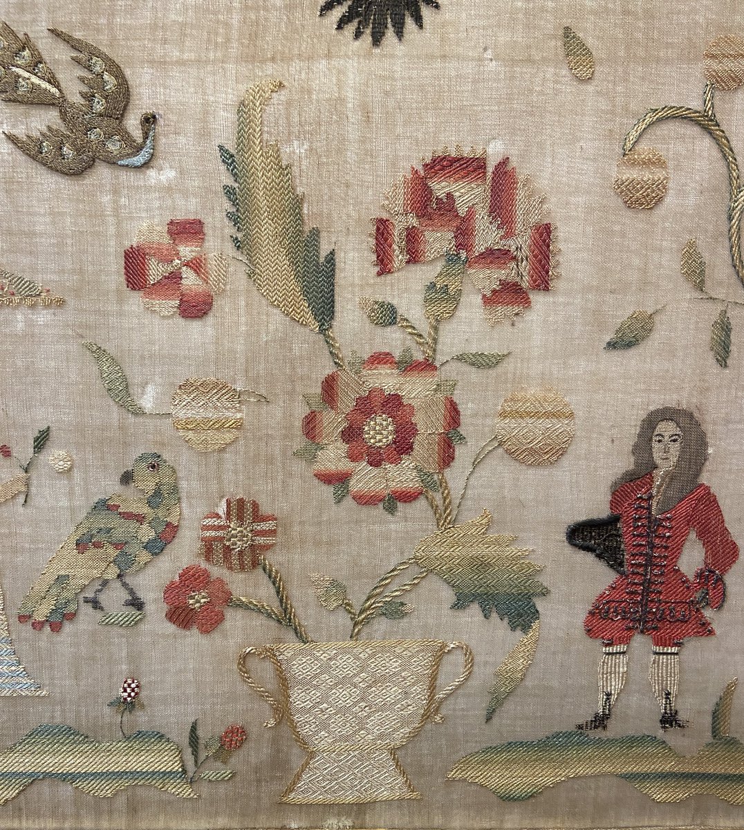 Here’s a detail from an exceptional embroidered panel worked entirely in darning stitches. Dating to the first years of the 18th century, it’s significantly larger and earlier than most decorative darning exercises. It’s on display in our annual exhibition, open for 3 more days