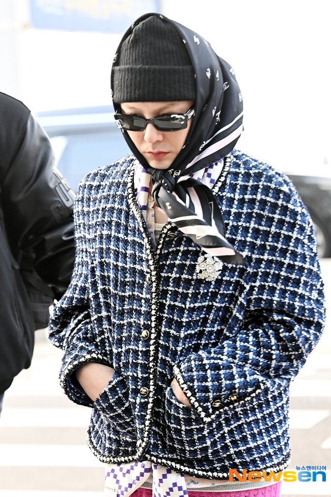 Jiyong wearing Chanel scarf, tweed jacket, glasses & pants to