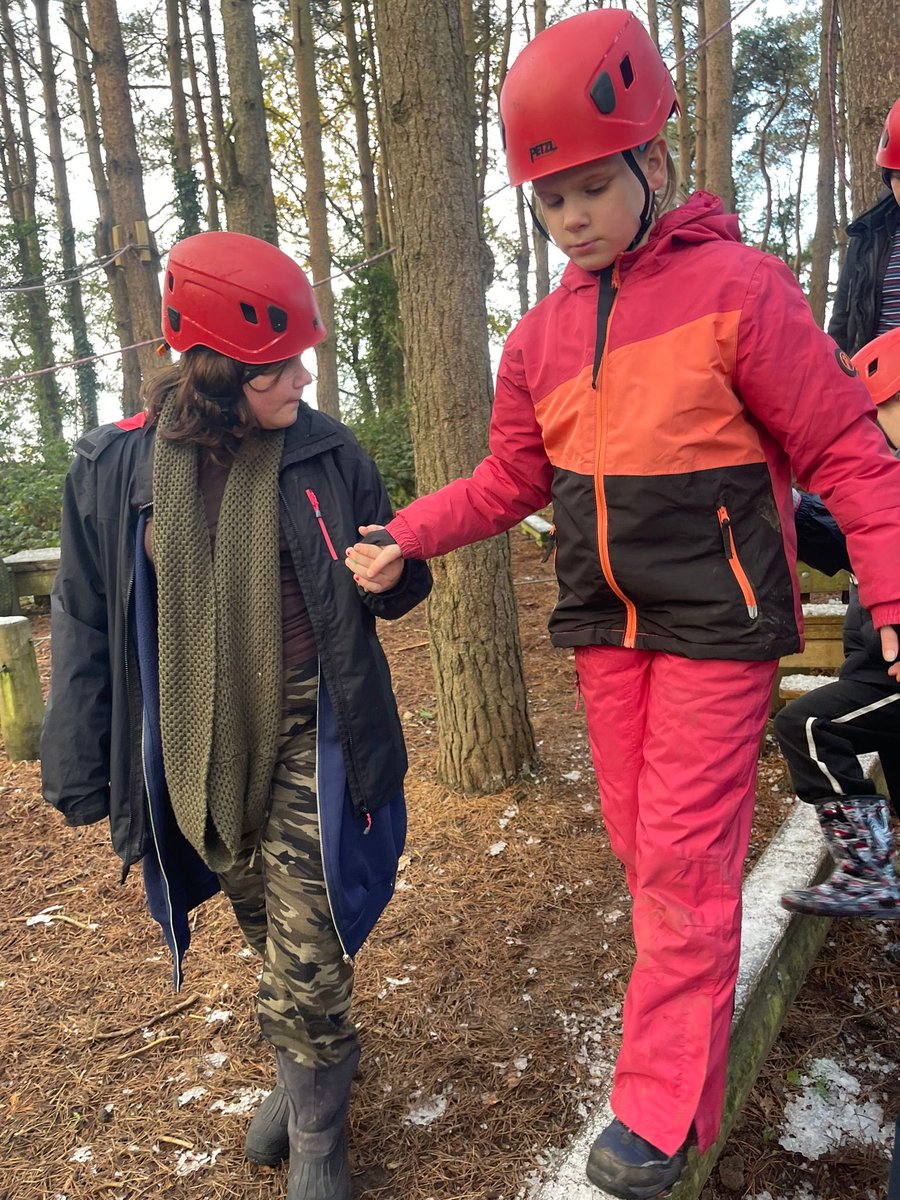 Giggles all around as we show off our balancing skills during the low ropes activity.