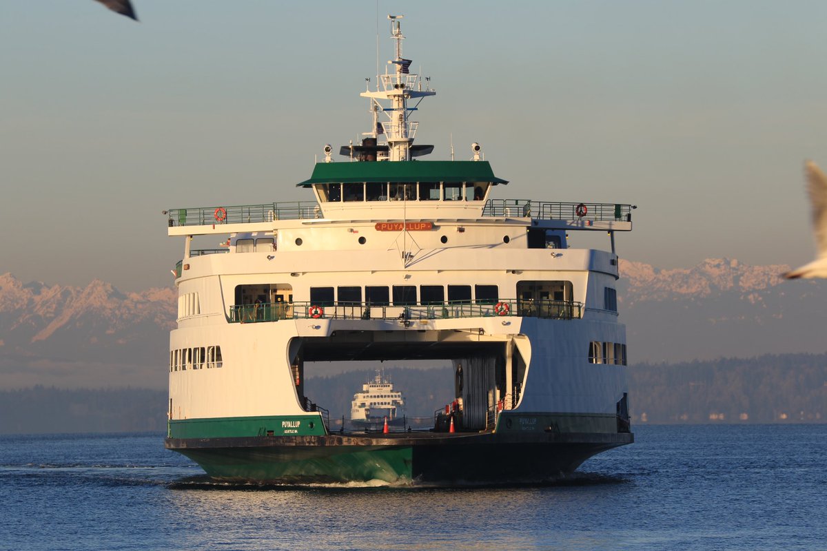 A ferry sailing towards the camera. Through the car deck, another ferry is seen sailing in the distance.