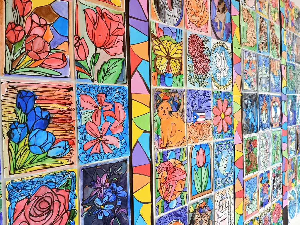 Students create a stained glass art piece by arranging colored glass-like pieces in a design. They learn about stained glass techniques and historical significance while expressing creativity through gallery, using glass leading and watercolor paint.