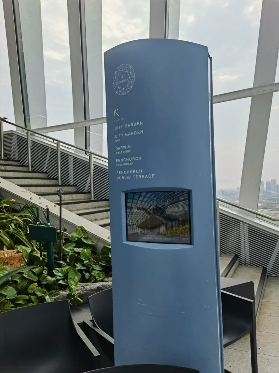 orientalli's tweet image. The interior of the Sky Garden featuring seating areas, visitors, and a view of the skyline through large glass panels.