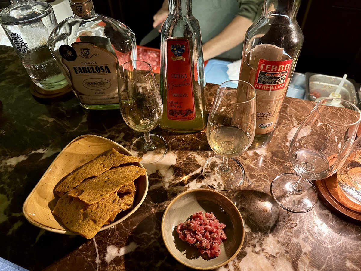 RobiMangia's tweet photo. Last night at Bar Tarobá in the @Belmond Cataratas 🌴 Another Cachaça flight, this time with different wood barrels. Chatted up Antonio who used to be a sushi Chef for 14 years and he offered me some of the Beef Tartar he was making. Excellent! 🥃 https://t.co/8iyKRI5D3f