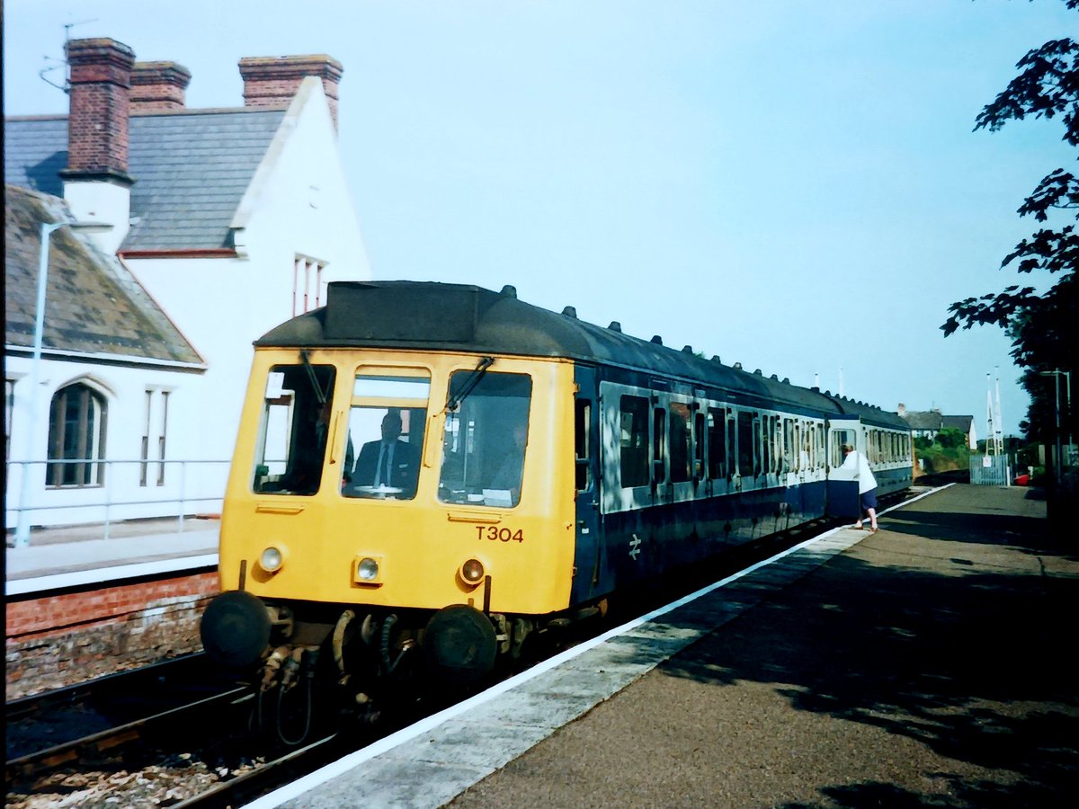 Invermuir's tweet image. Corporate Blue/Grey this week. Kicking off today, a bog triptych. T304, a shortened Pressed Steel class 117. Think it may have been the last blue/grey bog in operation. Exeter 1992 #tmrguk #BR #Class117.