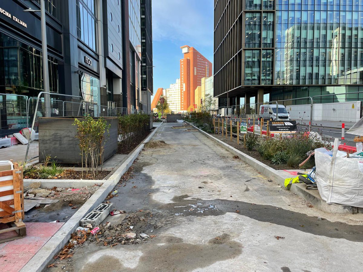 willnorman's tweet photo. The new cycle tracks,  sustainable drainage and planting is really transforming Westfield Ave in the Olympic Park - making the entire street much more people friendly. 

And what is that in the background? The first blue sky and sunshine I’ve seen this month. Wow! https://t.co/q18ltAbBEH