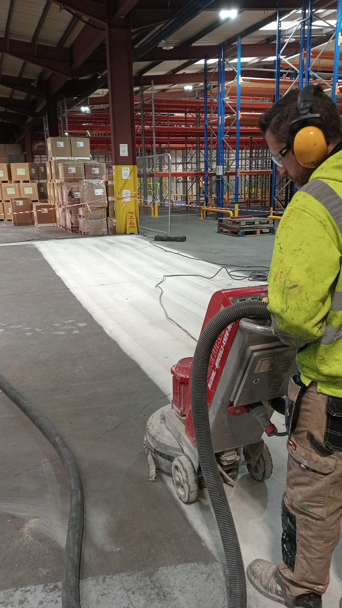 <a href="/floorpainters/">Floor Painters Ltd</a> floor preparation with grinder attached to industrial vacuum. Creating safe and hygienic working environments with <a href="/resbuild/">RBP Limited</a> epoxy coating