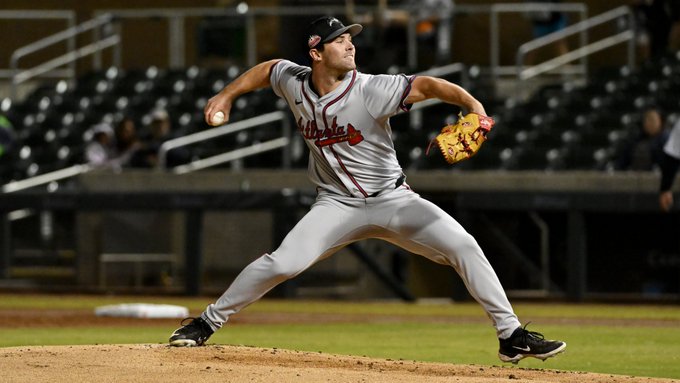 Braves prospect Adam Maier throwing a pitch for the Peoria Javelinas. He is wearing a gray Braves uniform. 