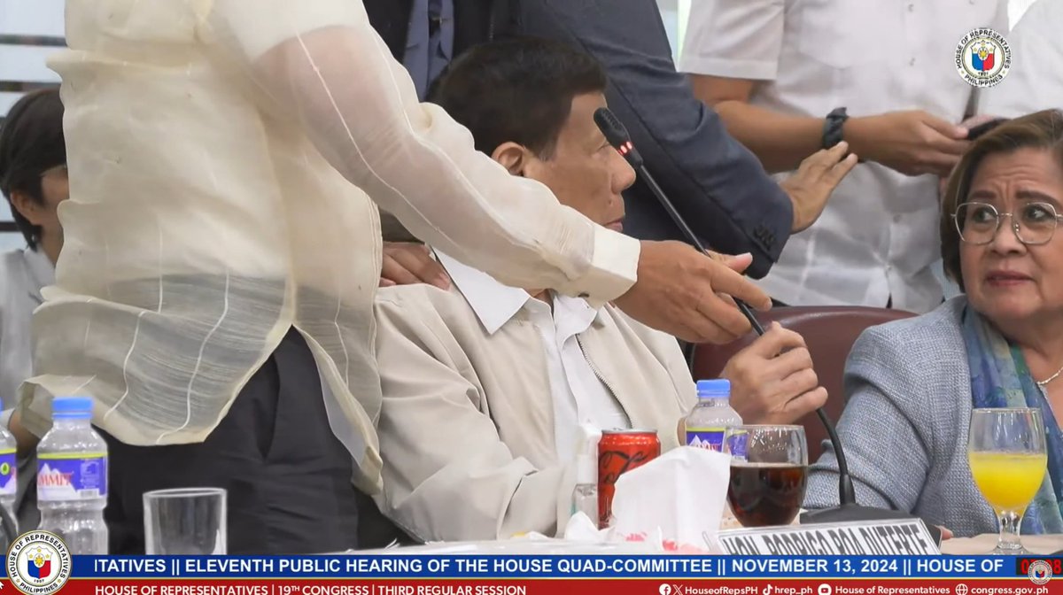 PhilstarNews's tweet photo. UMIINIT NA MGA EKSENA SA QUAD COMMITTEE HEARING

Former President Rodrigo Duterte appeared to lose his cool and attempted to throw his microphone after former senator Sonny Trillanes shared alleged bank records showing deposits of at least ₱2.4 billion under the names of Duterte’s family members, during the House Quad Committee hearing on Wednesday, November 13.

Watch the hearing live: https://t.co/q9HpFg8NpK

📸 Screenshots via House of Representatives