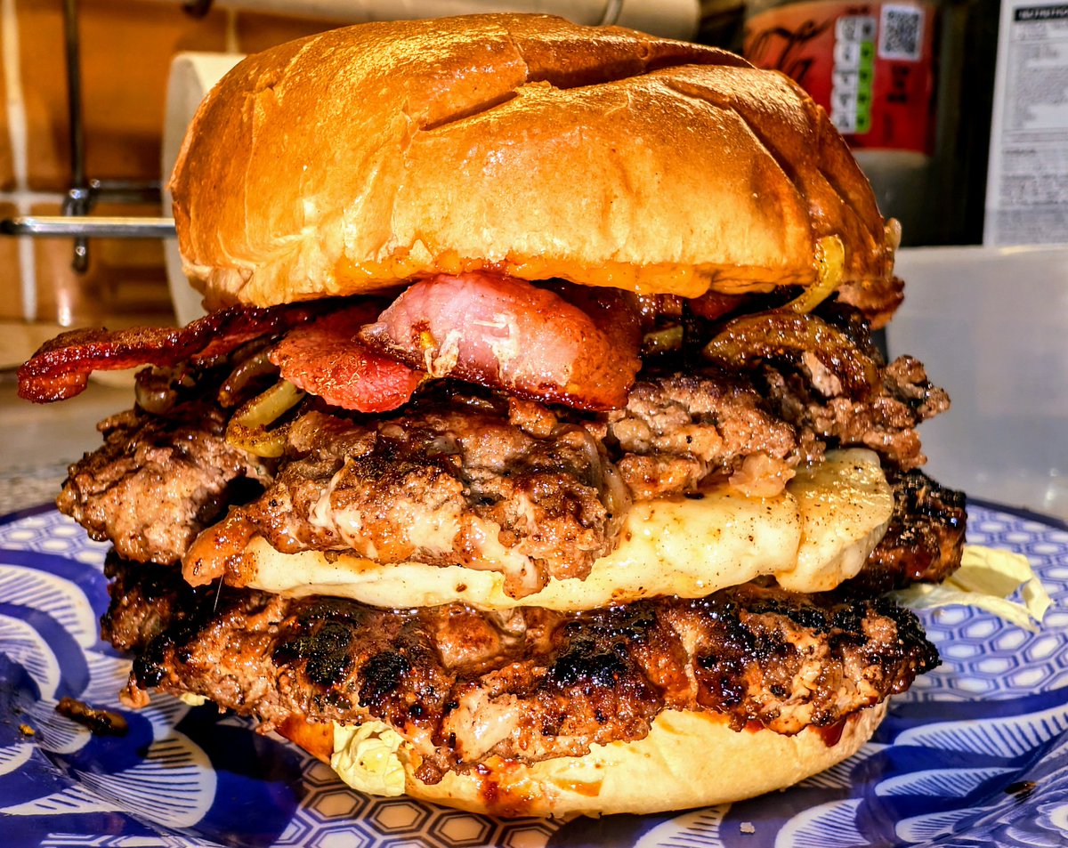 SirLARIATO's tweet photo. Lamb Bacon Double Cheeseburger, with Bahārāt spiced lamb, crispy smoked bacon, grilled halloumi cheese, Chinese cabbage leaf, Advieh-e khoresh spiced fried onions, a tahini chili mayo and a pomegranate barbecue sauce. https://t.co/jza5a2IERM