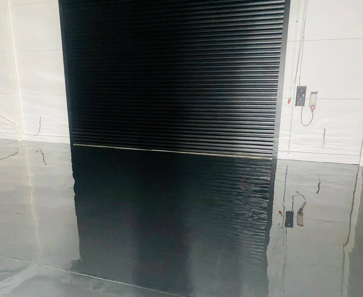 Epoxy resin screed Anthracite, applied to floor of classic car storage garage.