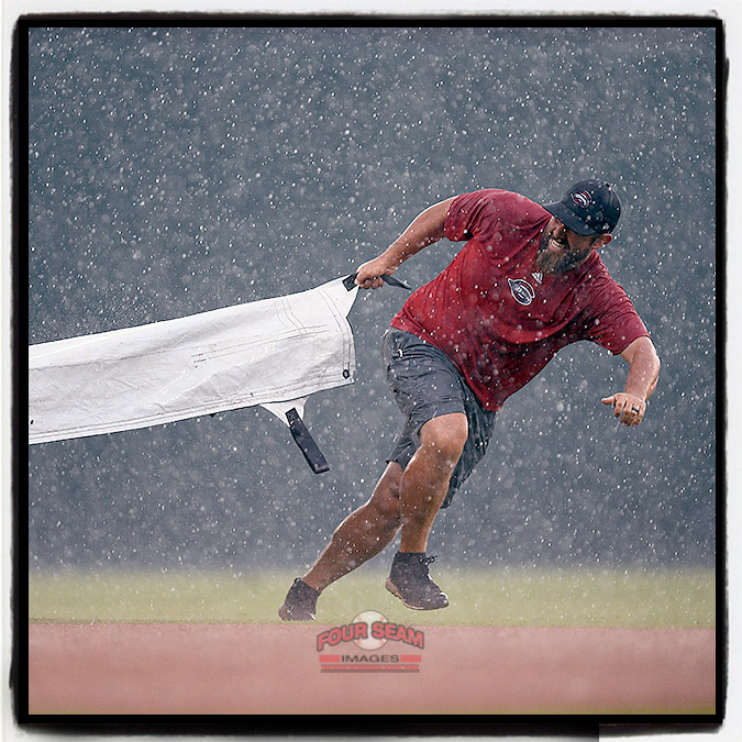 The Greenville Drive’s Vice President of Operations and Grounds Greg Burgess has been named South Atlantic League Head Groundskeeper of the Year for the seventh time. Here Burgess pulls the tarp during a sudden downpour at a game in 2018.  (Tom Priddy/Four Seam Images)