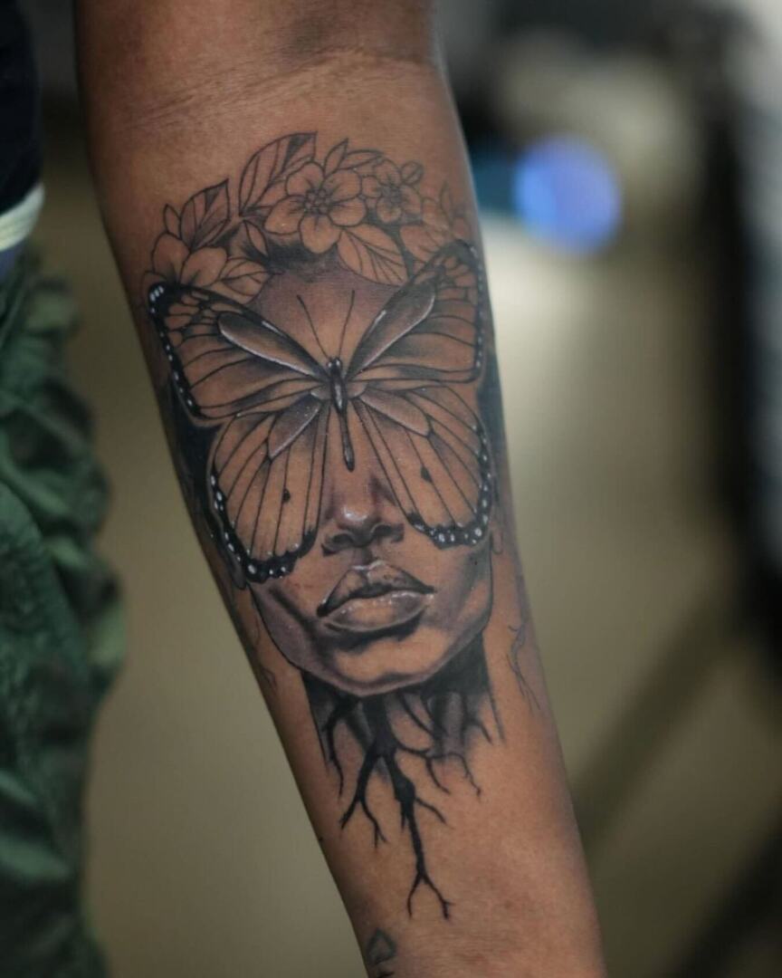 Repost from American tattoo society of Ft Liberty ( @atsftliberty ) • A  captivating tattoo featuring a woman's face blended with a butterfly, with  its wings spread across her eyes. Floral elements, image size:864x1080