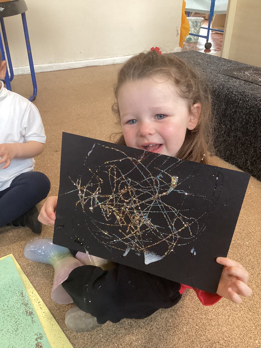 PCPNursery's tweet photo. We got independent &amp; creative to make our own unique spider webs using glue and glitter. We didn’t spread the glue, but instead used different arm movements to drizzle it onto the paper before adding some glitter. Just like spider webs, no two were the same! #pcpart https://t.co/QItX7dRwF9