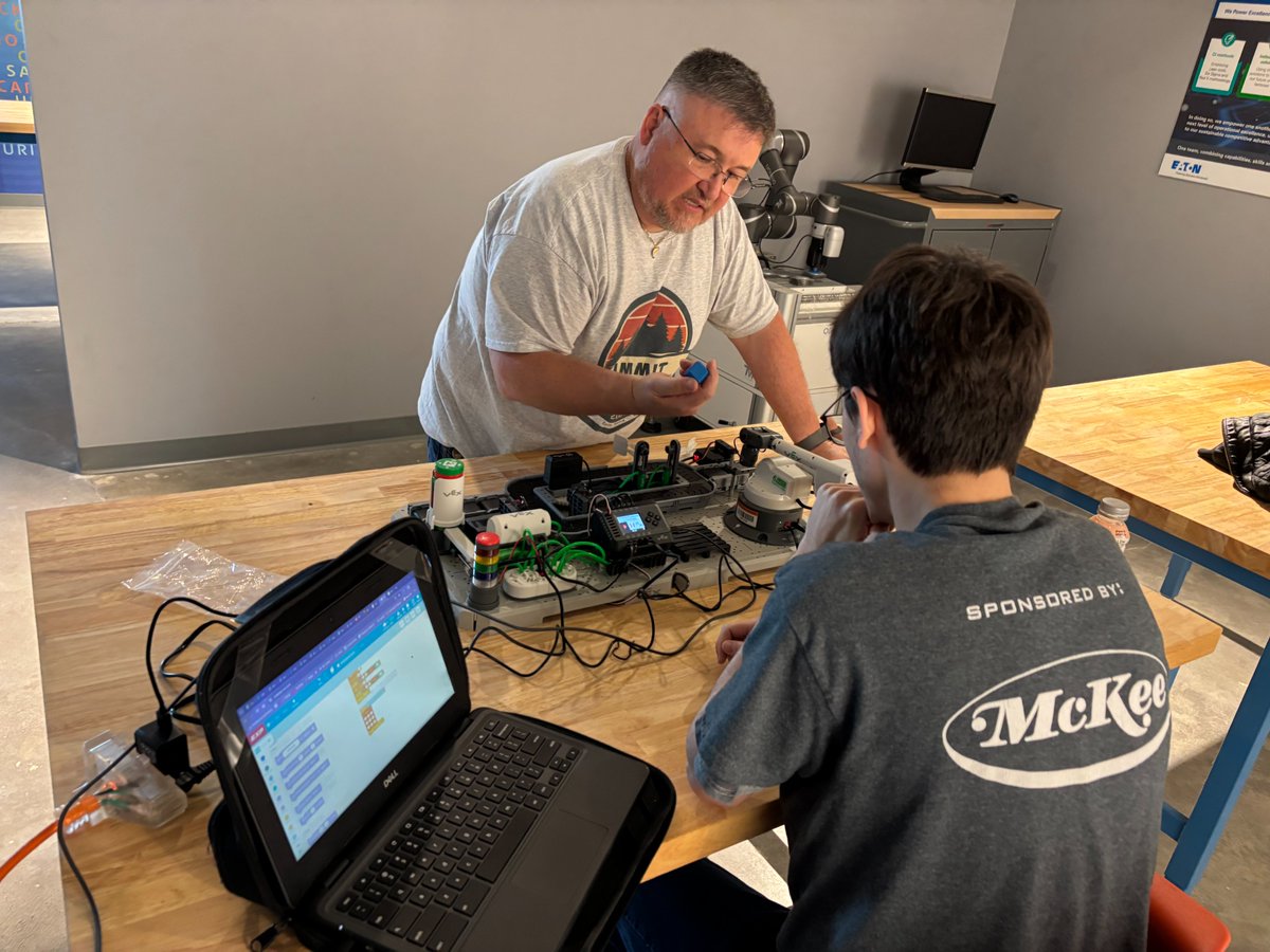 TechnologyBCS's tweet image. BCHS Senior, Denny Gardner and @PIE_Center_BCS Mechatronics teacher Dak Keylon work to create an automated sorting program on a VEX CTE Workcell, as a part of the Motor Controls and Practicum classes. This equipment is on loan from the new BCS STEM Hub lending library. #STEMHub