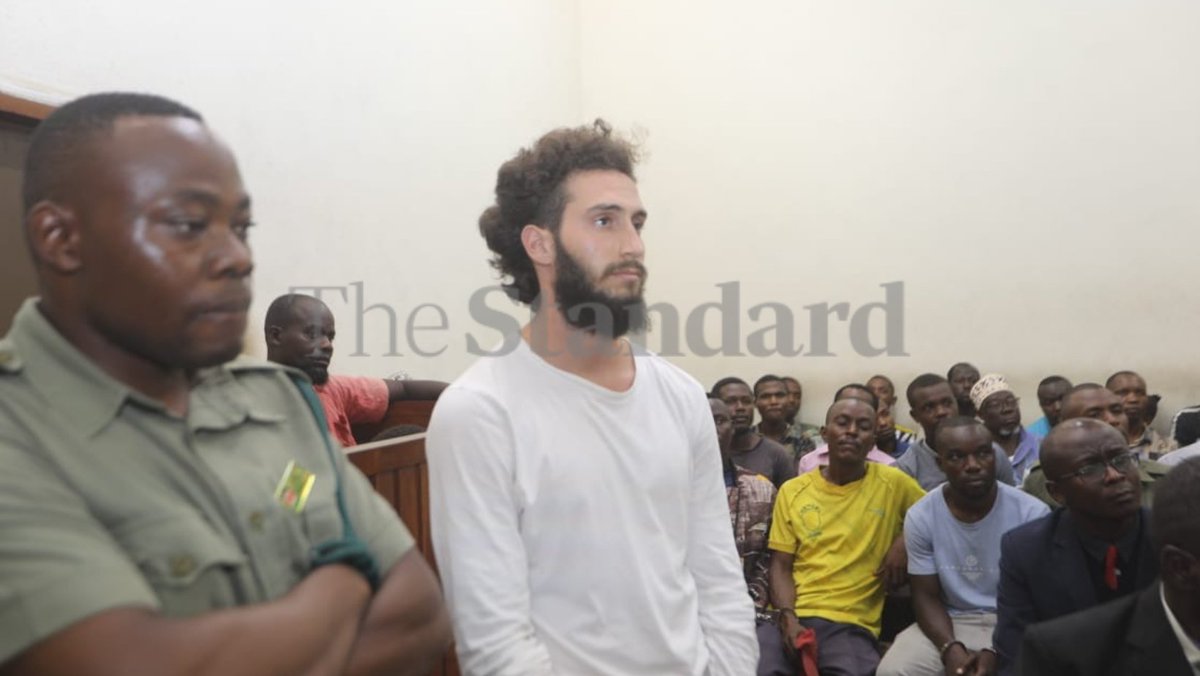 StandardKenya's tweet photo. American Zachary Aaron Katz appeared in a Mombasa court today, after the Anti-Terror Police Unit  investigated him for terrorism over a cartridge. The cartridge was traced to Israel, and no evidence linked him to terrorism, leading to his release. 

Photo by Kelvin Karani. https://t.co/uvjzq4nn8c