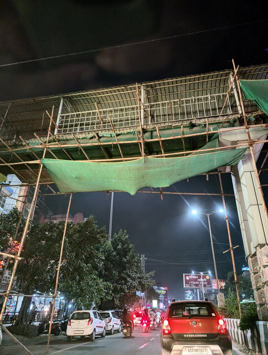 #alert A disaster in waiting. This is the footbridge at Lachit Nagar , Guwahati ( near KFC ) . Looks like a big stone or boulder hanging on the green fabric. Kind attn <a href="/gmc_guwahati/">Guwahati Municipal Corporation</a>