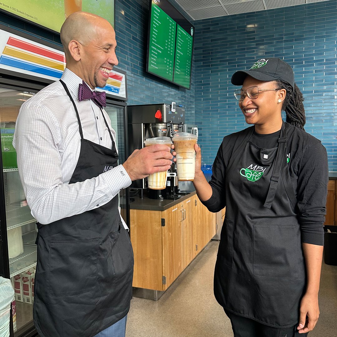 montgomerycoll's tweet photo. .@montgomerycoll President @DrWilliams_MC chats with MBI student & barista Nabou Syllaaa about her experience with the Macklin Business Institute (MBI) while making drinks for customers on the run. Check out the video next week. #BackpacksOnTheGo #EducationMatters @mctvsocial https://t.co/oR73Nm30OM