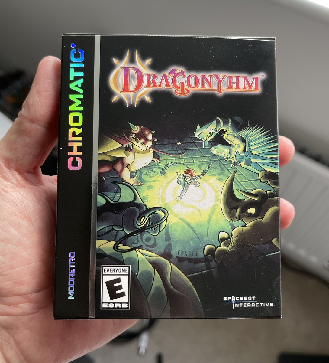 spacebot_dev's tweet photo. The pre-production Dragonyhm boxes came in and we couldn’t be happier. It’s surreal to see how good the game looks on the @modretro Chromatic. We’re so excited for everyone to start receiving their copies! #indiedev #IndieGameDev #indiegames #dragonyhm #RPG #spacebotinteractive #modretro #chromatic