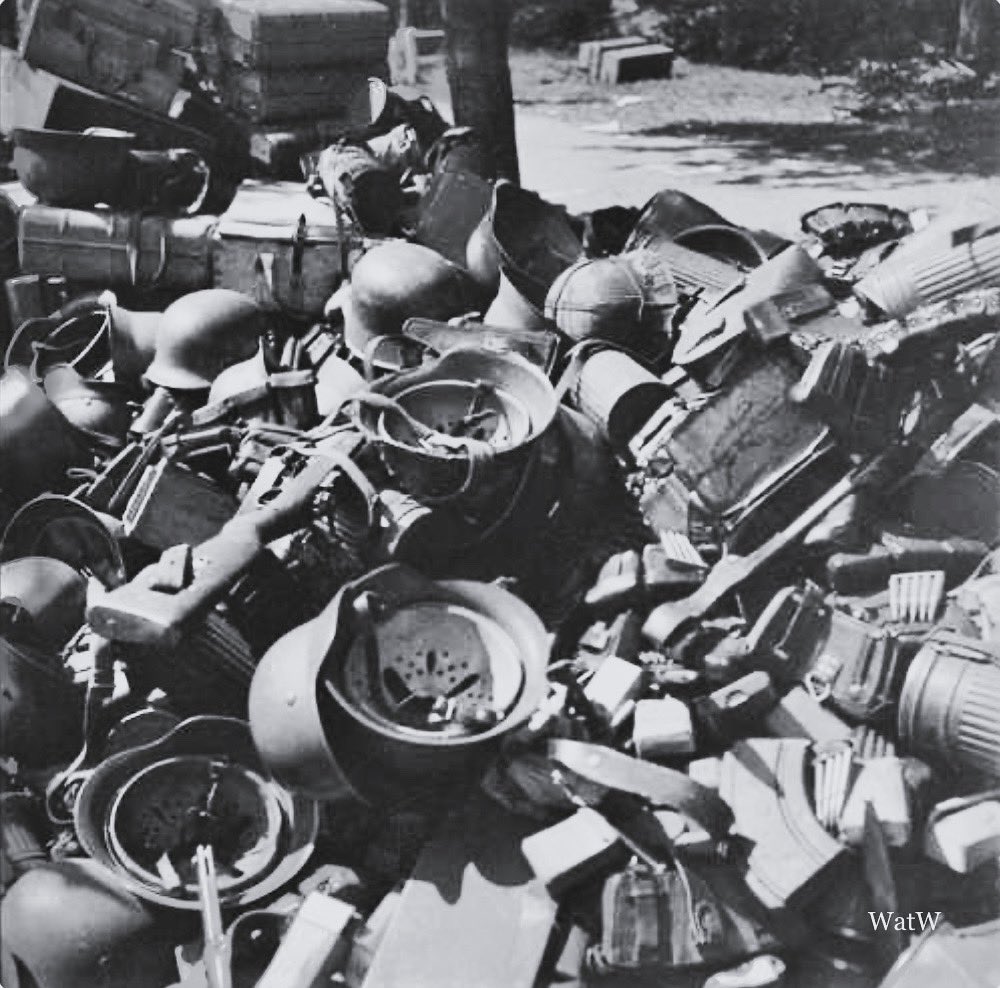 TheWorldatWar2's tweet image. German helmets and various pieces of equipment lay abandoned in the street - Soest, Netherlands, 10th May 1945 
#materiel #soest #netherlands #may1945 #abandonded #surrender