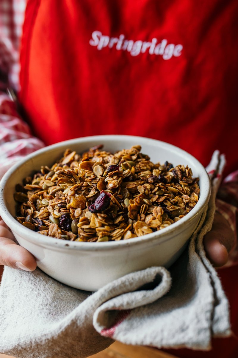 Many years ago, we set out to make the very best granola.

We started with favourite things:  flaked oats and almonds, plump dried cranberries, golden raisins, and big pecan pieces.  We sweetened it with fresh honey from our farm, mixed it by hand, and baked it right here.
