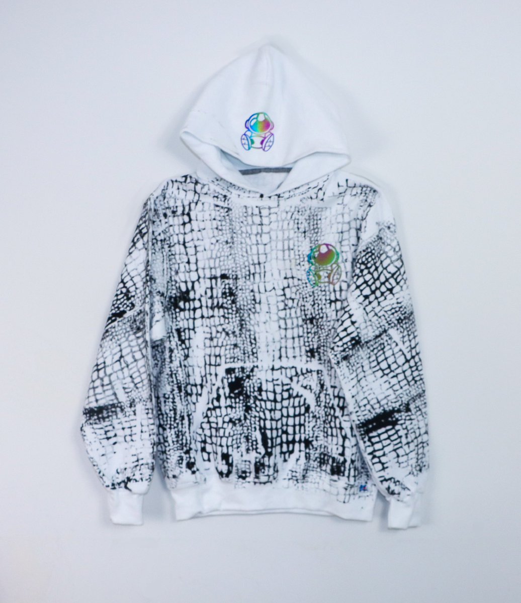 astroancient's tweet image. Introducing the 2025 Year of the Serpent Collection: the ultimate fusion of power, style, and mystique. This exclusive drop features a sleek white hoodie, adorned with a bold black snake print that embodies transformation and resilience.