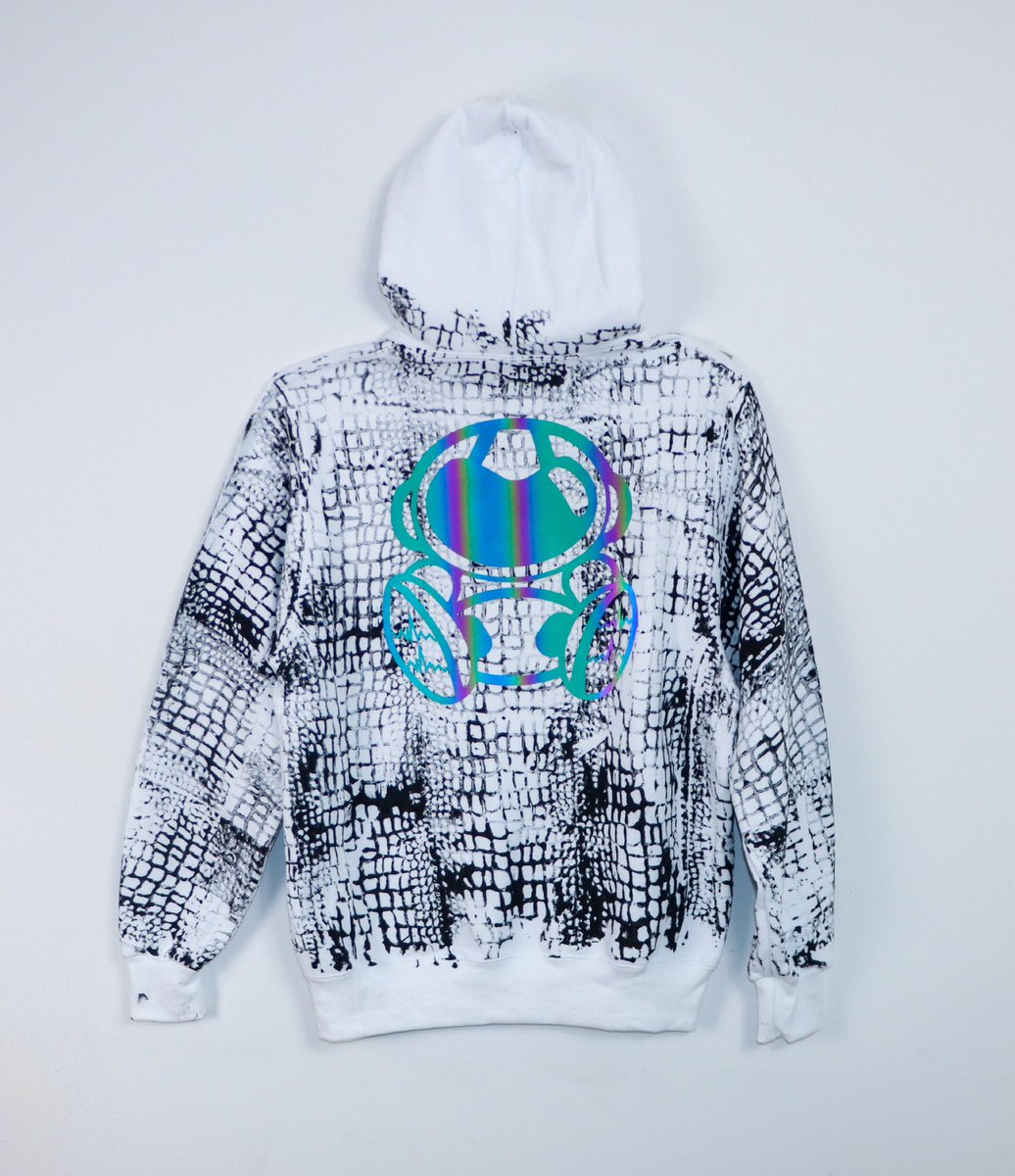 astroancient's tweet image. Introducing the 2025 Year of the Serpent Collection: the ultimate fusion of power, style, and mystique. This exclusive drop features a sleek white hoodie, adorned with a bold black snake print that embodies transformation and resilience.