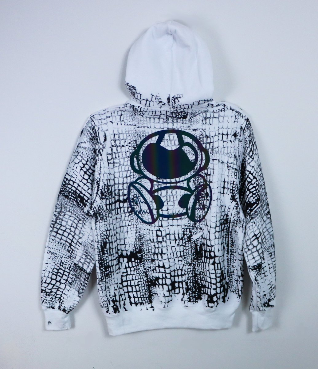 astroancient's tweet image. Introducing the 2025 Year of the Serpent Collection: the ultimate fusion of power, style, and mystique. This exclusive drop features a sleek white hoodie, adorned with a bold black snake print that embodies transformation and resilience.