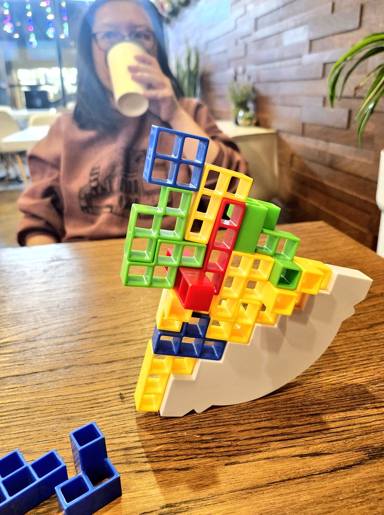 I'm a "serious gamer", and shouldn't enjoy this kind of thing but Grace and I  were at a coffee shop and played some Guess Who and a generic stacking game. 

And you know what?  We had a blast.  It's important to remember not to get too full of ourselves. Games are fun!