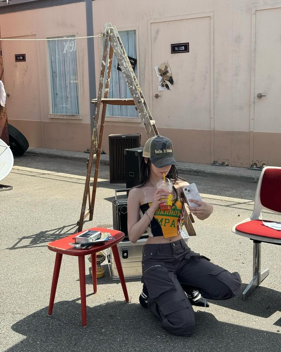 Lost in the rhythm of my own world, I sit under the sun, my cap shielding me from reality as I scroll through moments that feel like secret treasures.