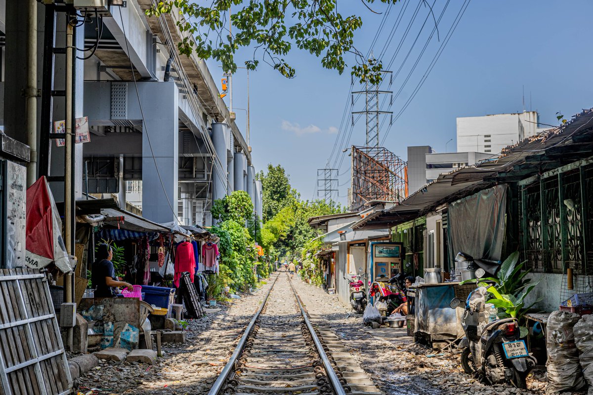 Got lost in #Bangkok today and ended up walking a railway line through a shanty town. Over an hour of smiles, chats, and buying treats for local kids from makeshift shops. Ended at Makkasan Station where old meets new. Unplanned adventures are the best. 🛤️📷 #BangkokAdventures