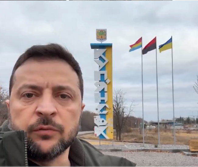 Dispropoganda's tweet photo. Here is Volodymyr Zelensky posing with the black and red UPA flag proudly waving behind him. 

The UPA was a Ukrainian militia in WW2 which was formed by the collaborator and ally of Nazi Germany, Stepan Bandera.  

Bandera was a Ukrainian fascist who partnered with Nazi Germany and helped it implement its "final solution" in Ukraine, until he was arrested in 1941 and sent back to Germany. 

His UPA was responsible for one of the worst genocides during WW2, the Wolyn genocide, killing over 100,000 Poles. 

The Ukrainian UPA tortured their victims with unimaginable bestiality. Even the Germans were shocked at their level of sadism. 

Victims were scalped. They had their noses, lips and ears cut off. They had their eyes gouged out and hands cut off and they had their heads squashed in clamps. Woman had their breasts cut off and pregnant woman were stabbed in the belly. Men had their genitals sliced off with sickles.

Professor Timothy Snyder, one of the most pro Ukraine Western Historians, wrote that Bandera's OUN (which later became the “Ukrainian Insurgent Army” or UPA):
  
“...helped the Germans organize murderous pogroms of Jews, Poles and other minorities. In so doing, they were advancing a German policy, but one that was consistent with their own program of Ukrainian ethnic purity. Bandera aimed to make of Ukraine a one-party fascist dictatorship without national minorities.”

Despicable doesn't begin to describe this.