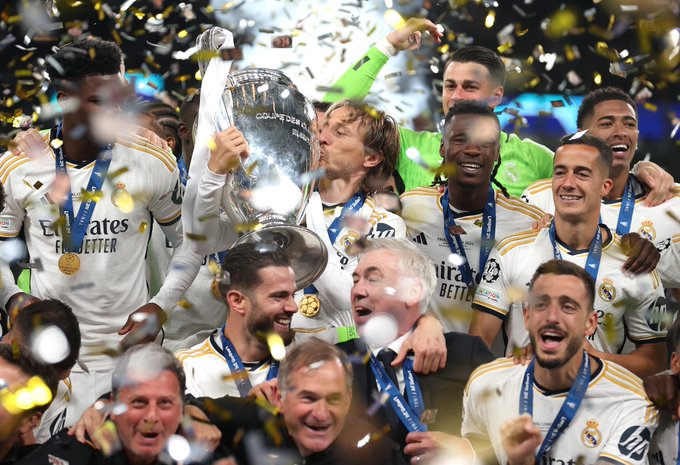 Real Madrid CF players celebrate with the UEFA Champions League trophy.
