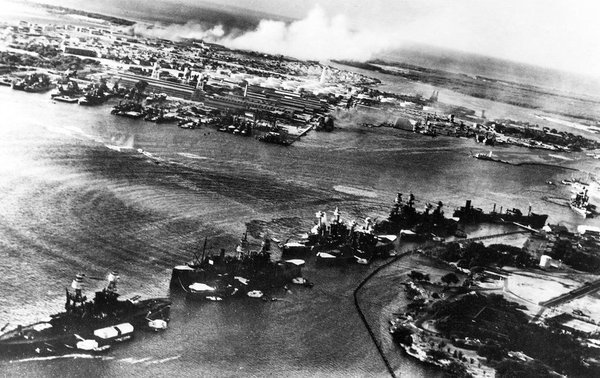 RIGHT NOW in 1941, the first Japanese warplanes appear in the skies over Pearl Harbor. The lead bomber transmits a pre-arranged signal to begin the attack: "Tora, Tora, Tora!" 

No alarm has been raised; the raiders have achieved complete surprise.
