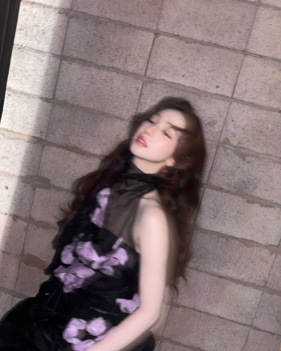 The sheer black fabric of my dress, adorned with delicate lilac flowers, moved gently with each shift, wrapping me in a quiet elegance.