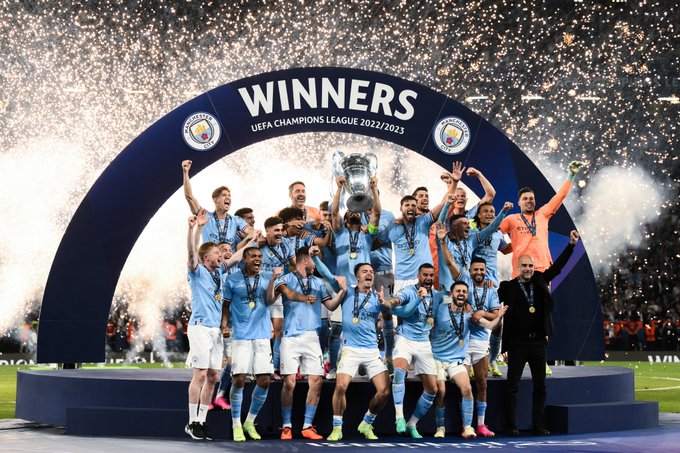 Manchester City FC celebrate with the UEFA Champions League trophy.