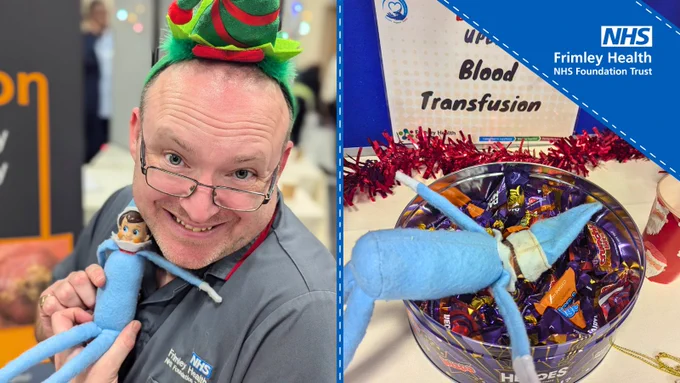 Person wearing a festive hat smiles while holding a plush toy at a Frimley Health NHS Foundation Trust event. Beside, a bowl filled with chocolates and wrapped gifts, decorated with tinsel.