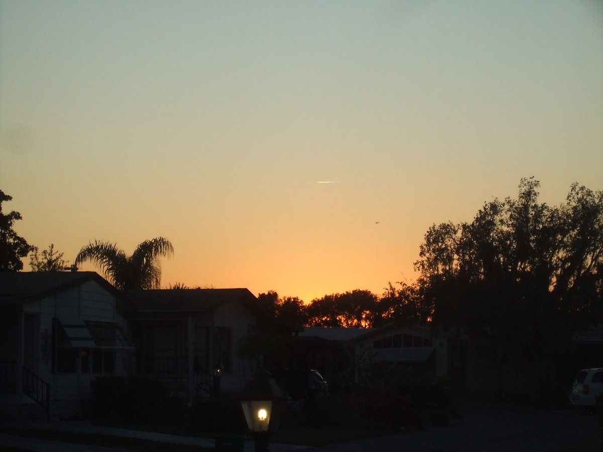 jaguarjulie's tweet image. Pretty sunset last evening at 5:26pm in Central Florida. I noticed a vapor trail and something flying parallel to that trail ... I have zoomed in on the second photo ... what do you think it is?? #whatisit