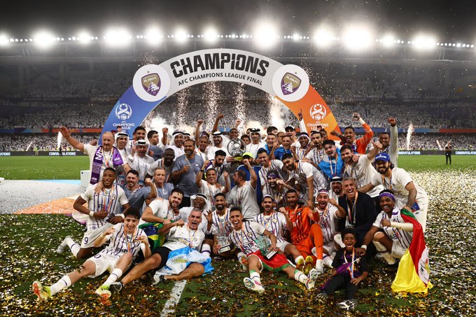 Al Ain FC celebrate with the AFC Champions League trophy.