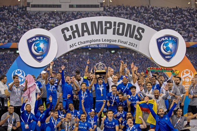 Al Hilal SFC players celebrate with the AFC Champions League trophy.