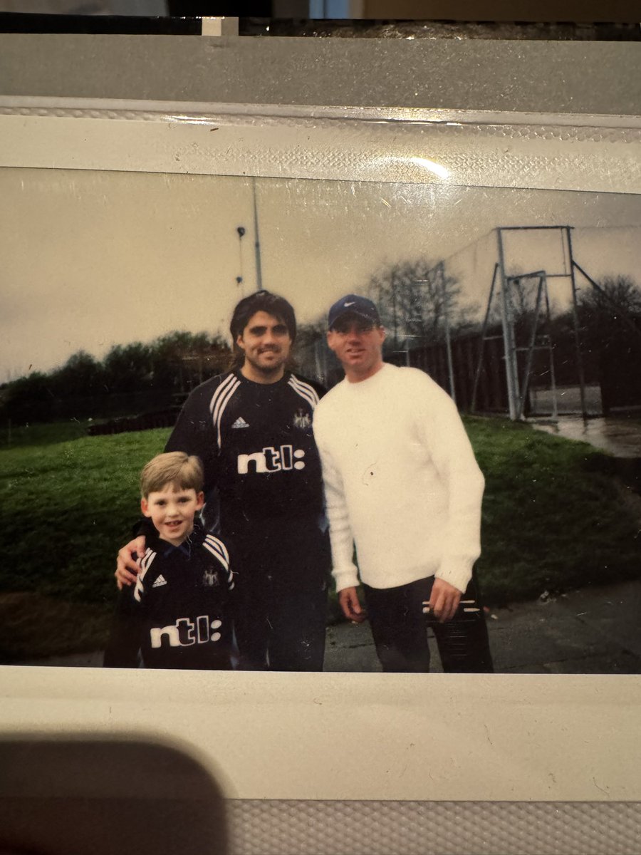 SHAMBAS_'s tweet image. Just found an old photo book. Fucking belta. Two of the big lads no longer with us. I have Speedo’s signed shirt from a 1-0 Derby game in ‘01 where I was ball-boy so getting that framed. Can’t wait! 

And who knew I’d chore @warrenbarton2 curtain haircut 20 year later 😂 #NUFC